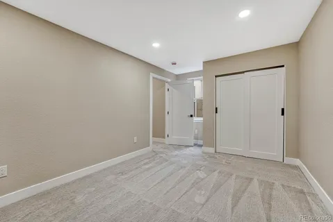 a bathroom with a sink and mirror with toilet