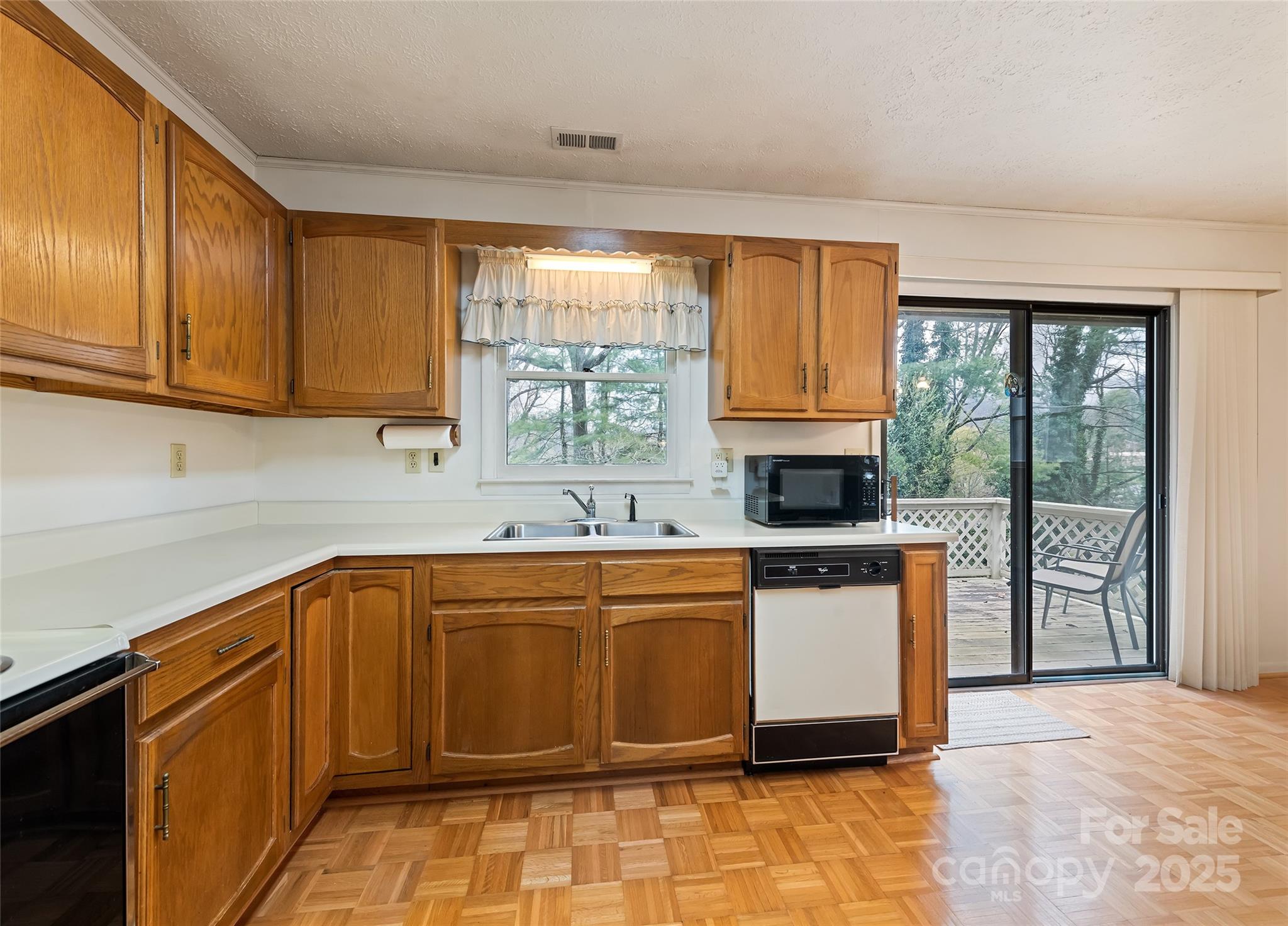 192 Poplar Drive Clyde, NC 28721 - Photo 11 of 33 a kitchen with stainless steel appliances granite countertop a refrigerator a sink a stove top oven and a dishwasher next to a window