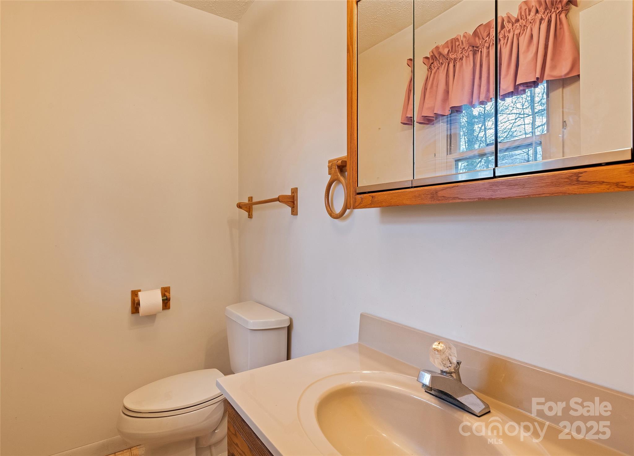 192 Poplar Drive Clyde, NC 28721 - Photo 15 of 33 a bathroom with a granite countertop sink and a toilet