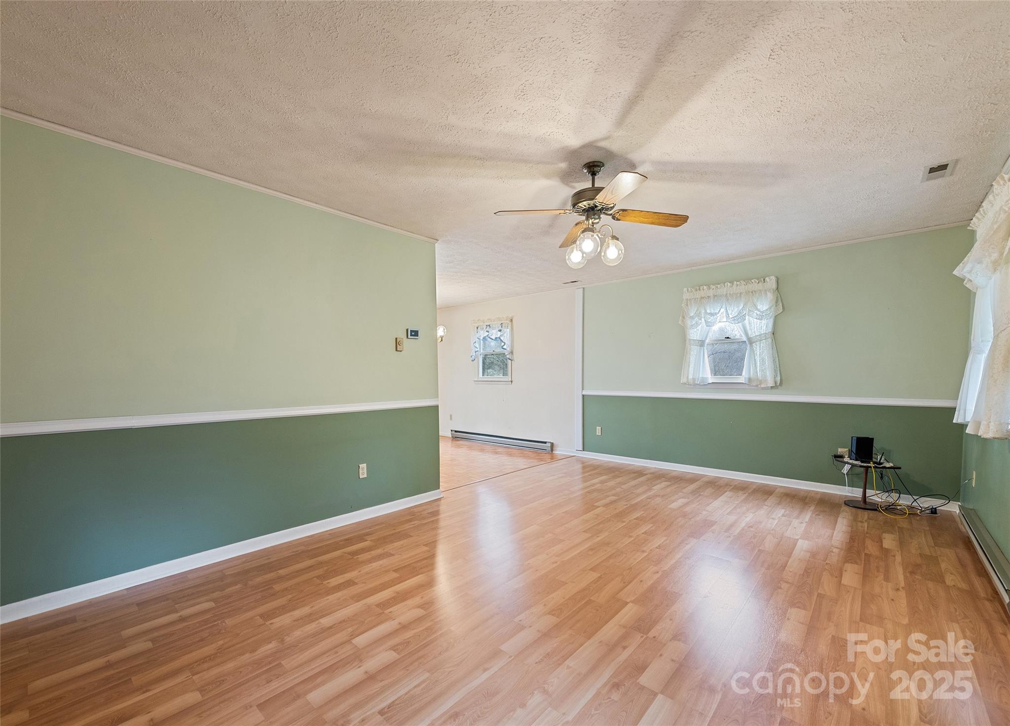 192 Poplar Drive Clyde, NC 28721 - Photo 6 of 33 wooden floor in an empty room with a window