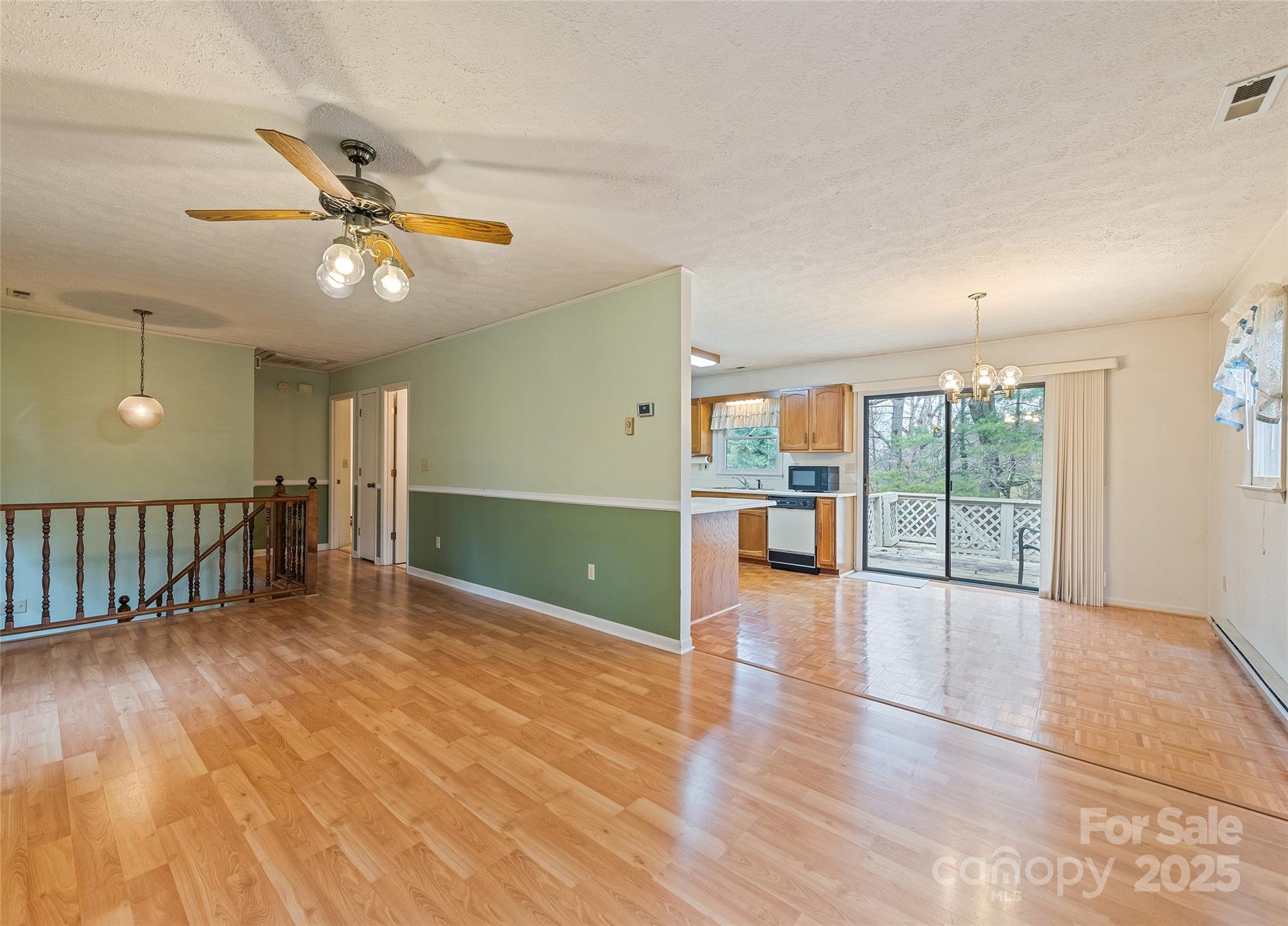 192 Poplar Drive Clyde, NC 28721 - Photo 7 of 33 a view of a livingroom with wooden floor and a ceiling fan
