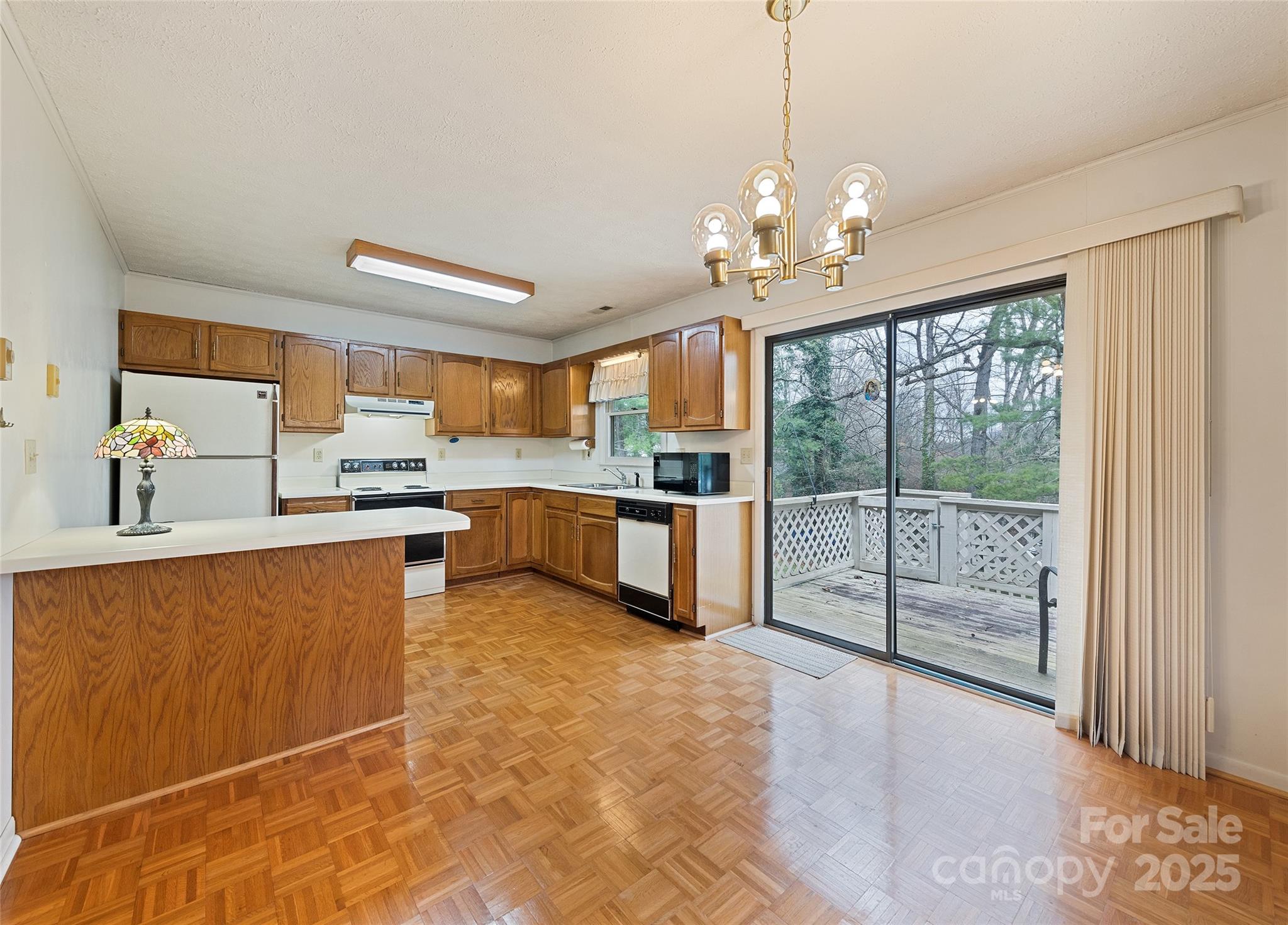 192 Poplar Drive Clyde, NC 28721 - Photo 8 of 33 a large kitchen with granite countertop a stove a sink and a refrigerator