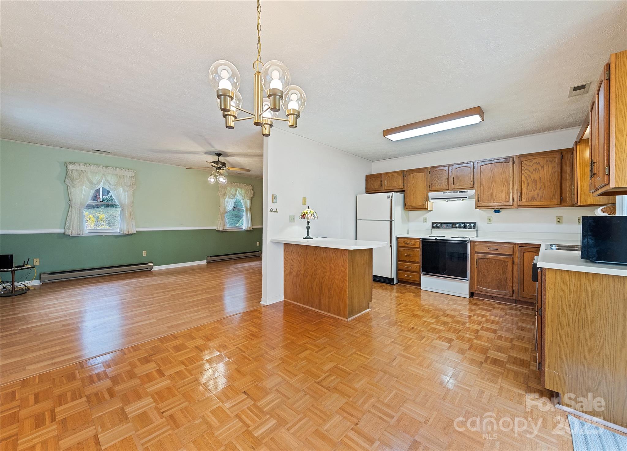 192 Poplar Drive Clyde, NC 28721 - Photo 9 of 33 a view of a kitchen with kitchen island a sink stainless steel appliances and cabinets