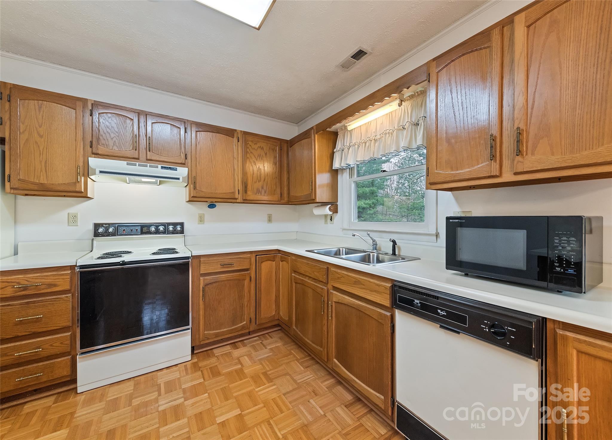 192 Poplar Drive Clyde, NC 28721 - Photo 10 of 33 a kitchen with stainless steel appliances granite countertop a stove a sink and a microwave