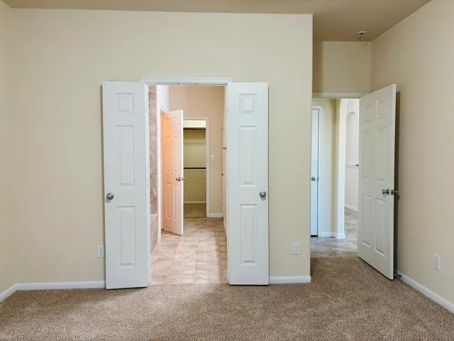 an empty room with closet and a bathroom