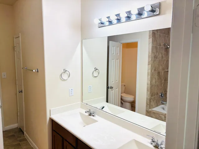 a bathroom with a sink a mirror and a shower
