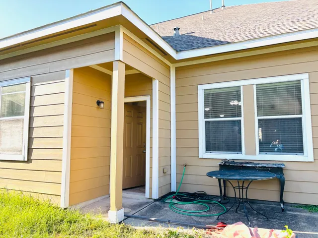 a view of a two chairs in front of a house