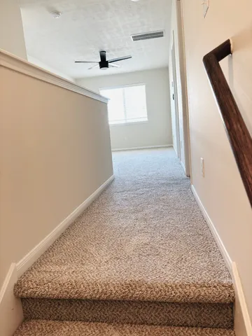 an empty room with a empty space and a ceiling fan