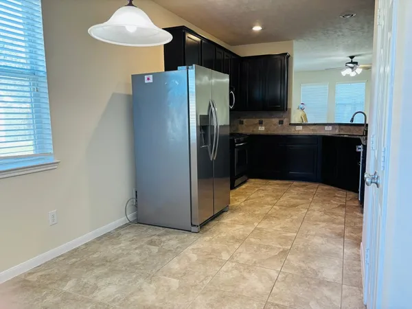 a kitchen with stainless steel appliances a refrigerator and a stove