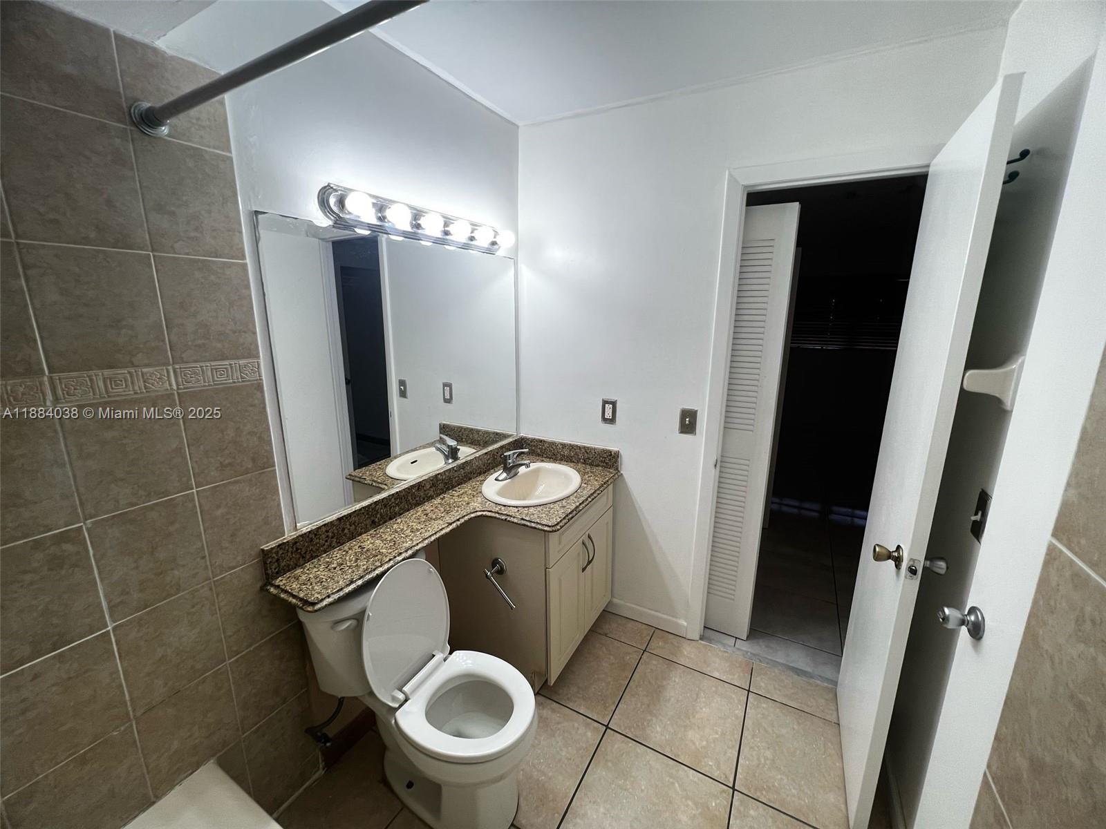 13345 Southwest 59th Lane Miami, FL 33183 - Photo 22 of 29 a bathroom with a granite countertop sink toilet and shower