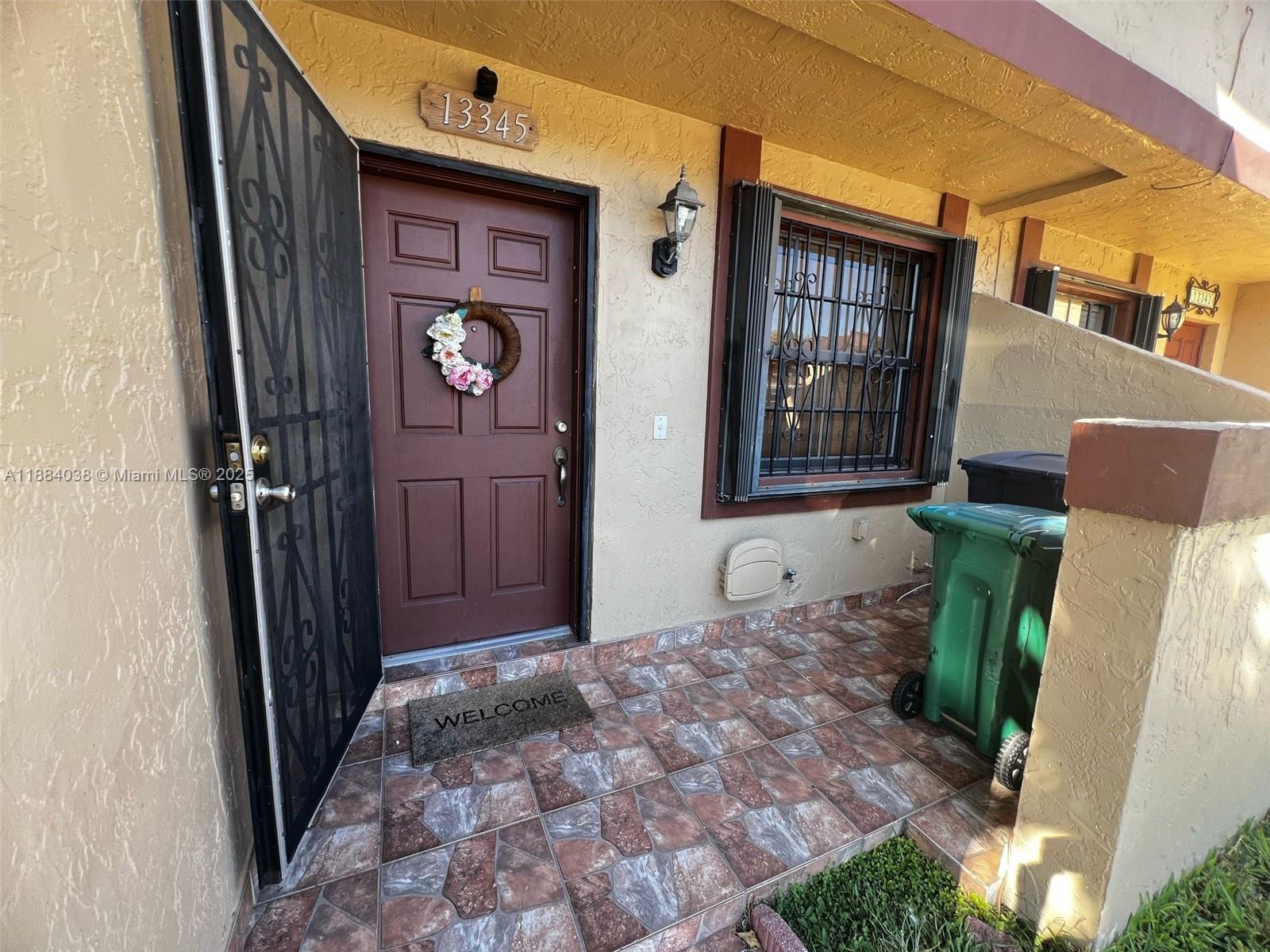 13345 Southwest 59th Lane Miami, FL 33183 - Photo 3 of 29 a front view of a house with entryway