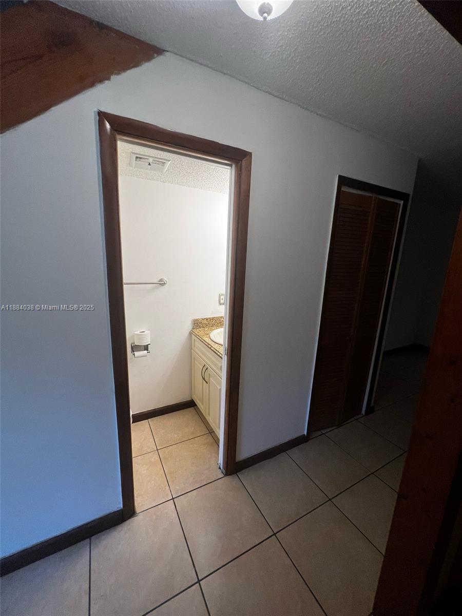 13345 Southwest 59th Lane Miami, FL 33183 - Photo 7 of 29 a bathroom with a granite countertop sink and a mirror