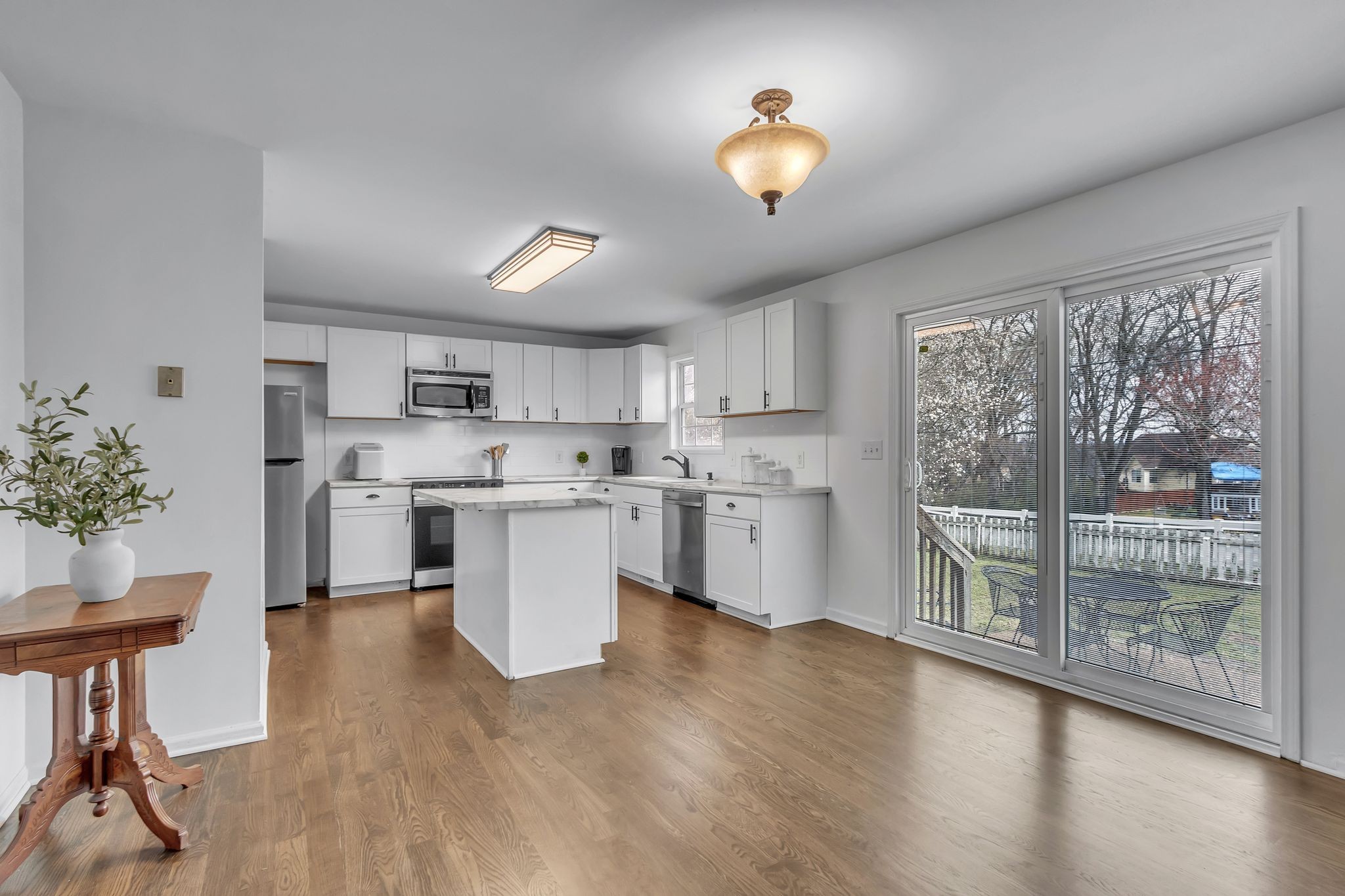 2006 Trenton Drive Spring Hill, TN 37174 - Photo 12 of 36 a kitchen with a table chairs microwave and cabinets