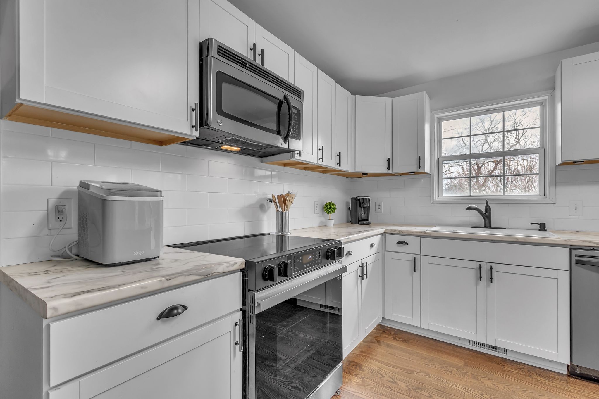 2006 Trenton Drive Spring Hill, TN 37174 - Photo 10 of 36 a kitchen with cabinets stainless steel appliances and a window
