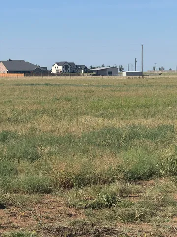 a view of a street with a big yard