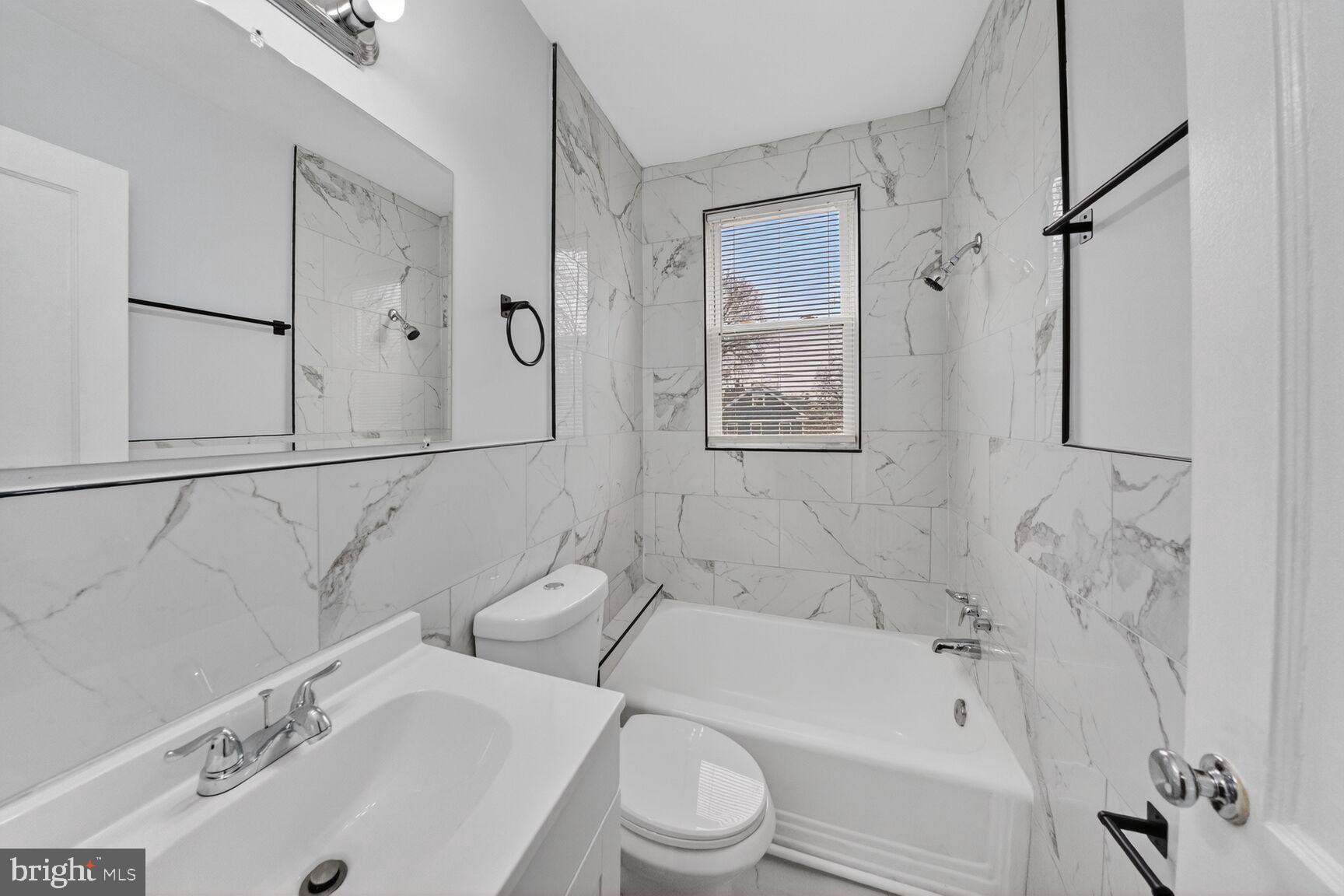 4701 Ravenswood Road, Unit 24 Riverdale, MD 20737 - Photo 10 of 14 Sleek marble bathroom oasis.