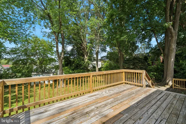 a view of balcony with wooden floor and fence