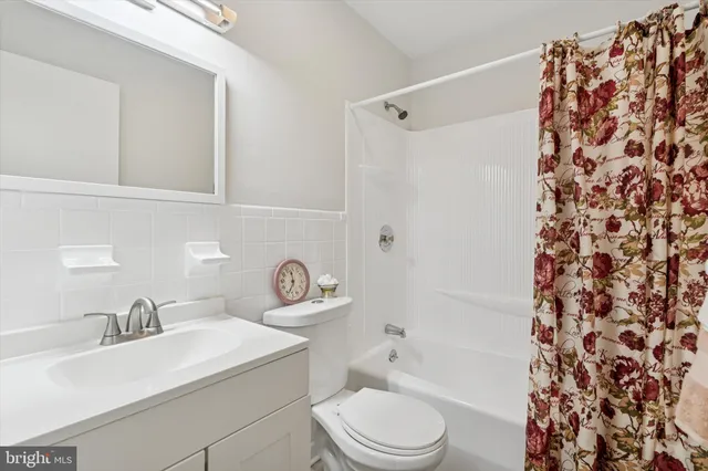 a bathroom with a sink toilet a mirror and shower