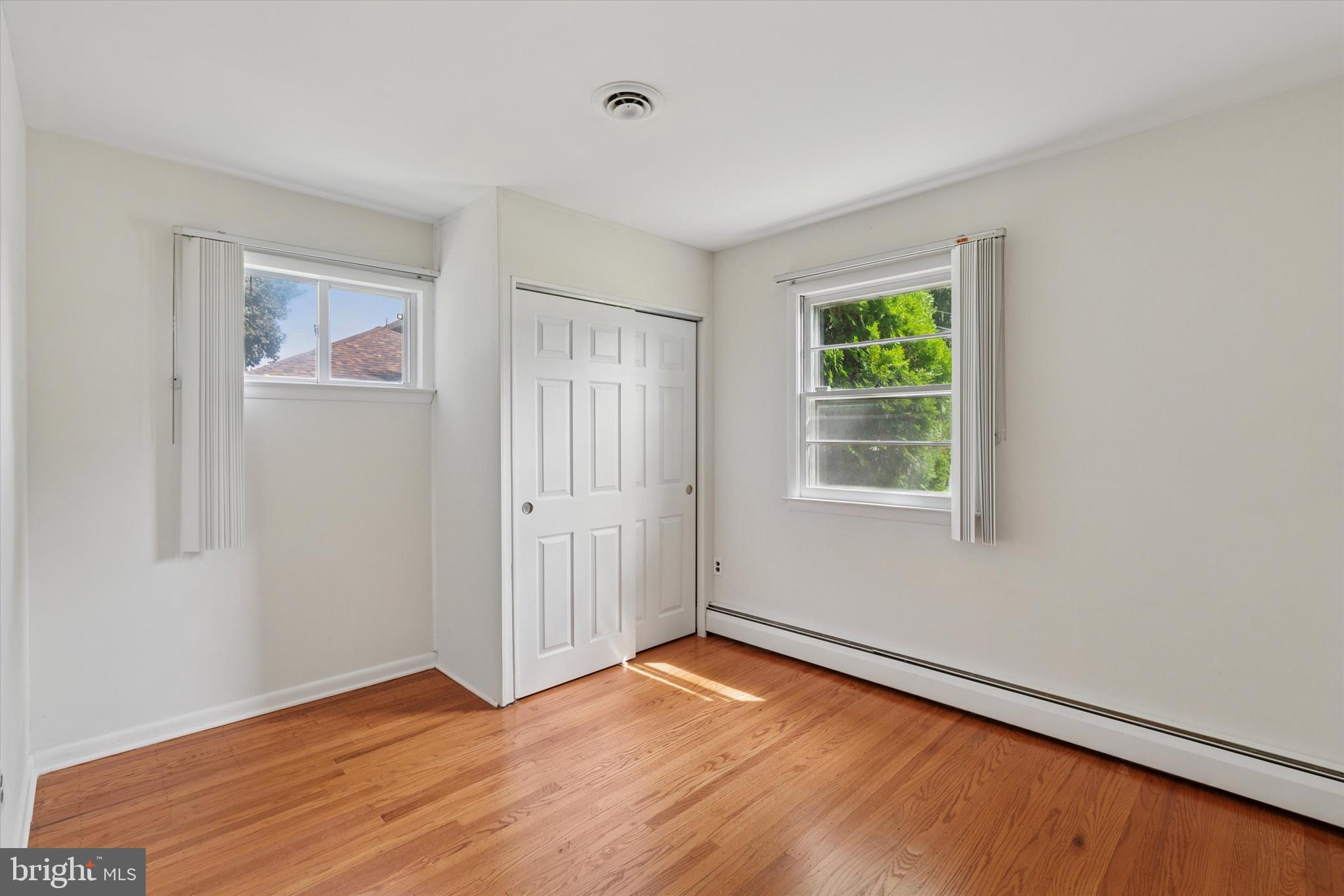 1948 Lukens Avenue Willow Grove, PA 19090 - Photo 10 of 23 an empty room with wooden floor and windows