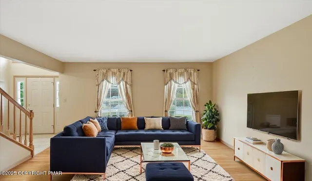 a living room with furniture and a flat screen tv