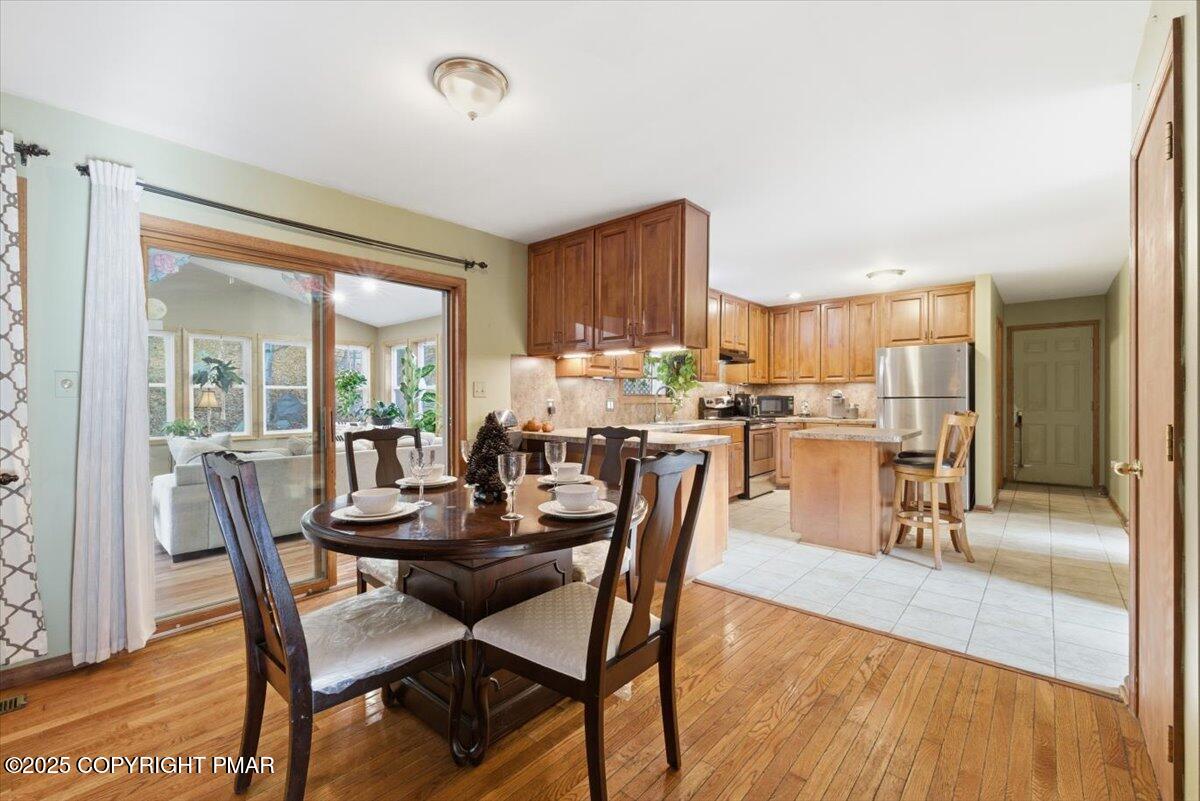 102 Arbor Way Stroudsburg, PA 18360 - Photo 24 of 50 a dining room with furniture and a wooden floor