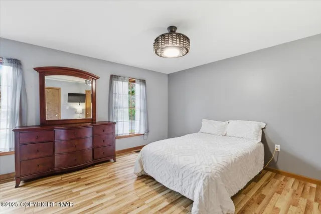 a bedroom with a large bed and a dresser