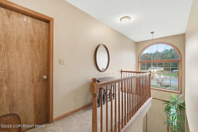 a view of a hallway with wooden floor and glass door