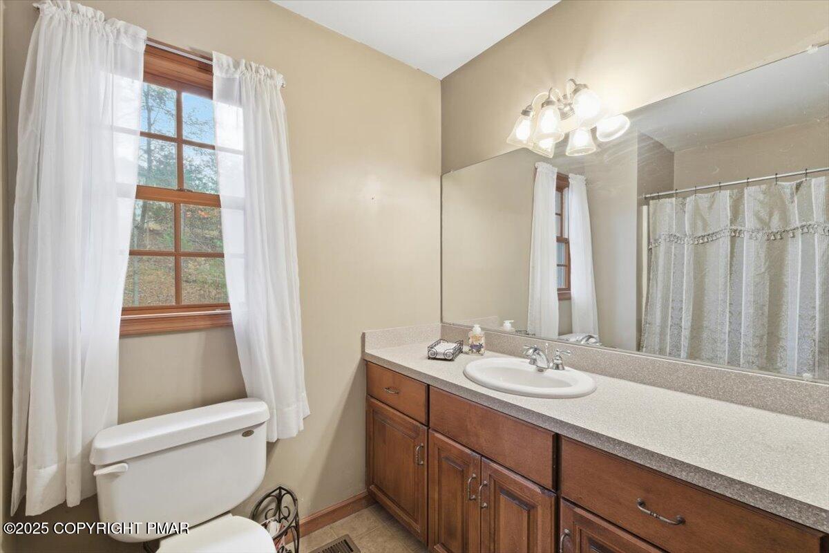 102 Arbor Way Stroudsburg, PA 18360 - Photo 33 of 50 a bathroom with a sink a toilet and a mirror