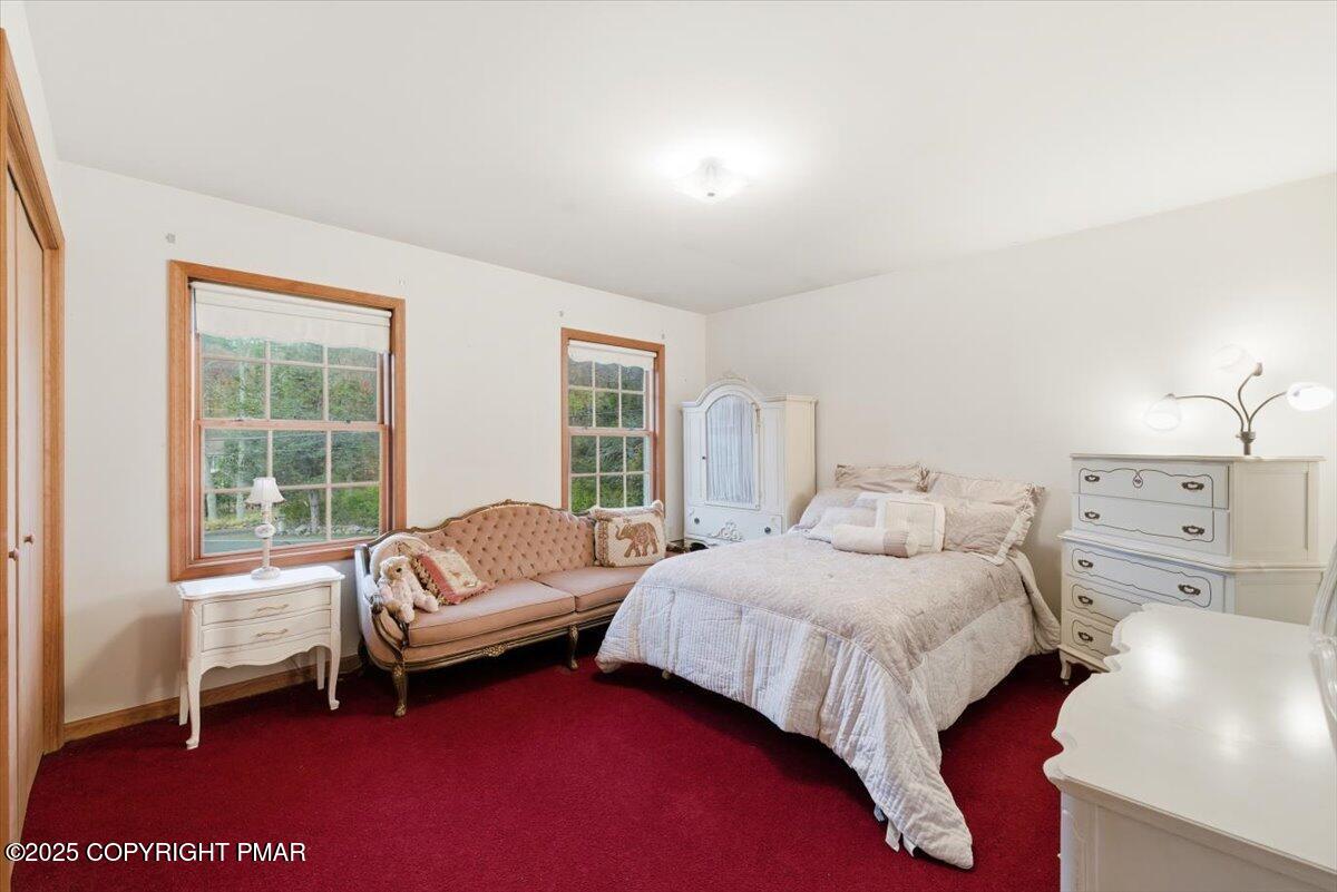 102 Arbor Way Stroudsburg, PA 18360 - Photo 35 of 51 a bedroom with a bed and a couch next to a window