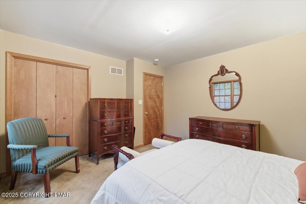 102 Arbor Way Stroudsburg, PA 18360 - Photo 37 of 51 a bedroom with a bed a dresser and chair