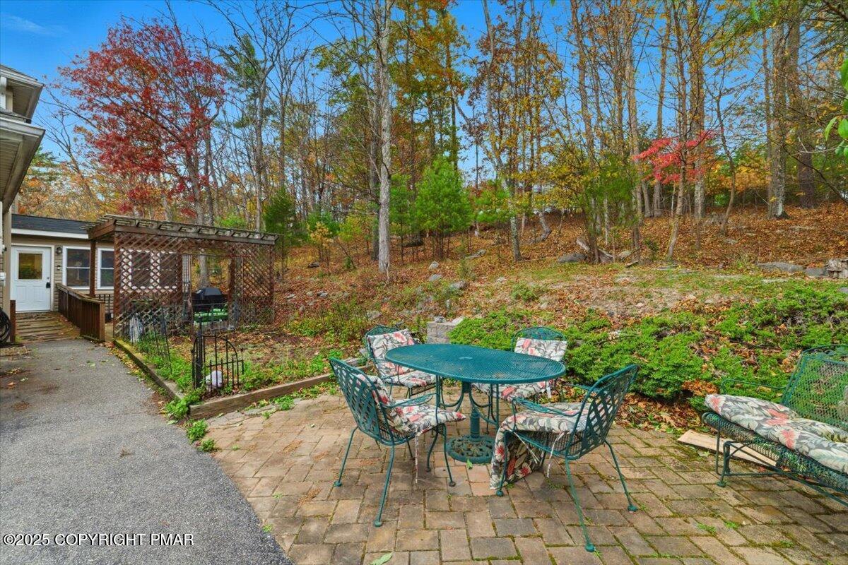 102 Arbor Way Stroudsburg, PA 18360 - Photo 41 of 51 a view of a chairs and table in backyard of the house