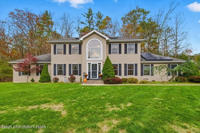a front view of a house with a yard