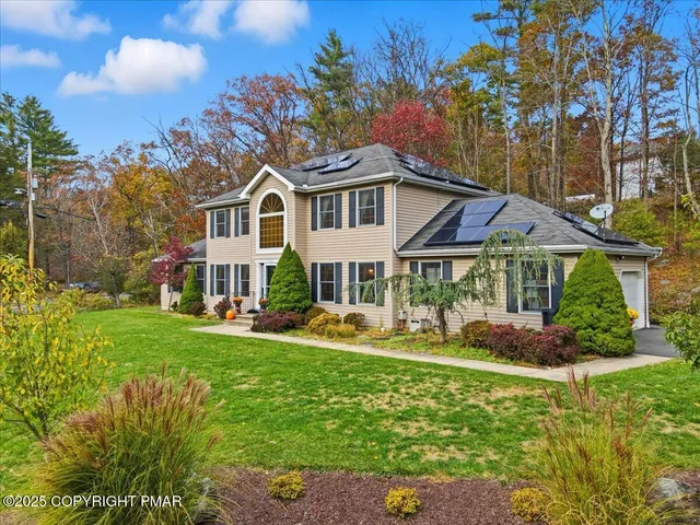 aerial view of a house with a big yard