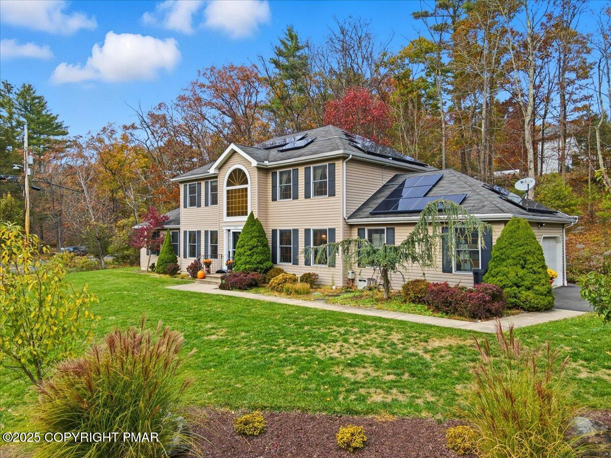 102 Arbor Way Stroudsburg, PA 18360 - Photo 49 of 51 a front view of a house with a garden and trees