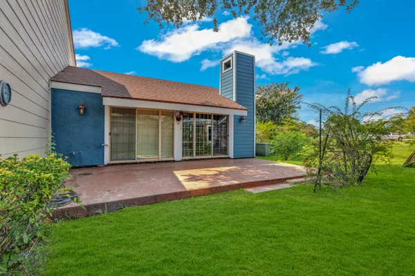 a front view of a house with a garden and yard