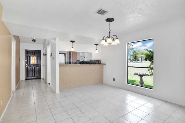 a view of a house with backyard porch and garden