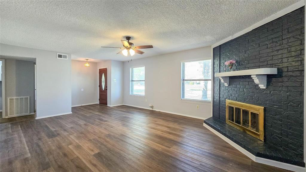 1526 Toyah Creek Lane Garland, TX 75040 - Photo 3 of 10 a view of an empty room with window and wooden floor