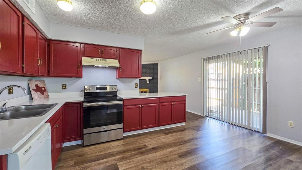 1526 Toyah Creek Lane Garland, TX 75040 - Photo 6 of 10 a kitchen with stainless steel appliances granite countertop a stove a sink dishwasher and a refrigerator with wooden floor
