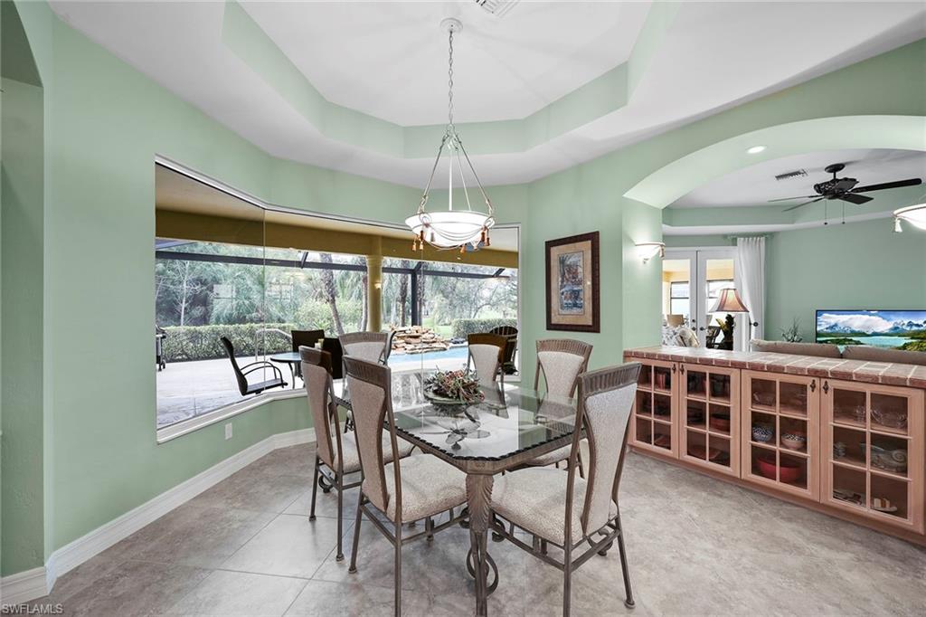 8862 Lely Island Circle Naples, FL 34113 - Photo 14 of 47 a view of a dining room with furniture window and outside view