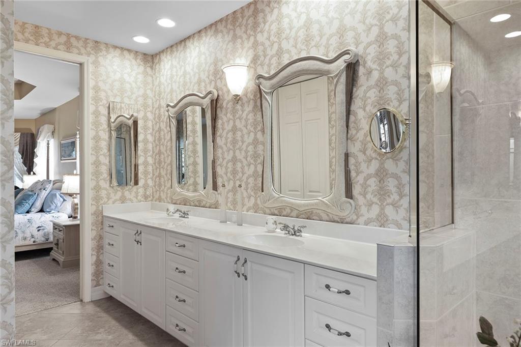 8862 Lely Island Circle Naples, FL 34113 - Photo 18 of 47 a bathroom with a double vanity sink mirror and double