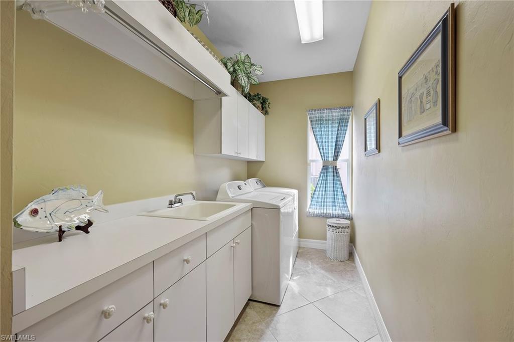 8862 Lely Island Circle Naples, FL 34113 - Photo 26 of 47 a utility room with a sink dryer and washer