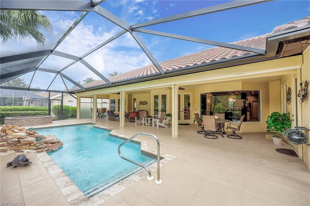 8862 Lely Island Circle Naples, FL 34113 - Photo 28 of 47 a view of a patio with swimming pool table and chairs