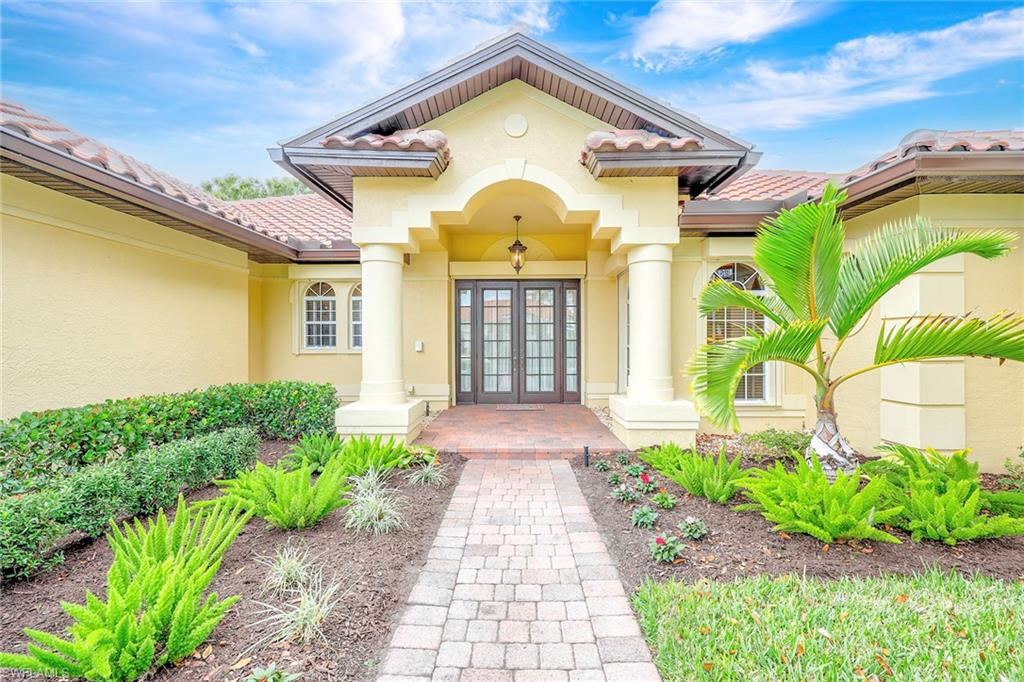 8862 Lely Island Circle Naples, FL 34113 - Photo 3 of 47 a front view of a house with garden