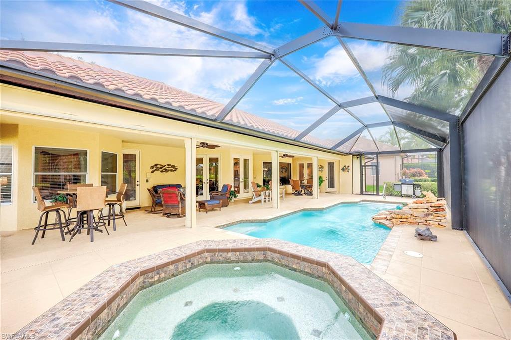 8862 Lely Island Circle Naples, FL 34113 - Photo 34 of 47 a swimming pool with outdoor seating
