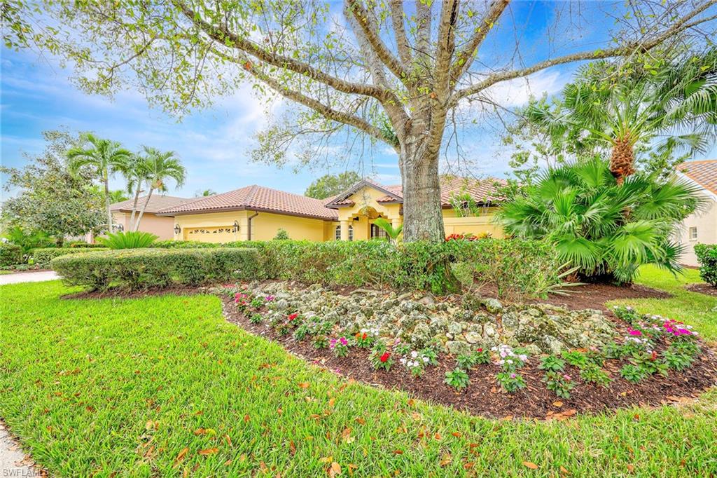 8862 Lely Island Circle Naples, FL 34113 - Photo 37 of 47 a view of a garden with a flower garden