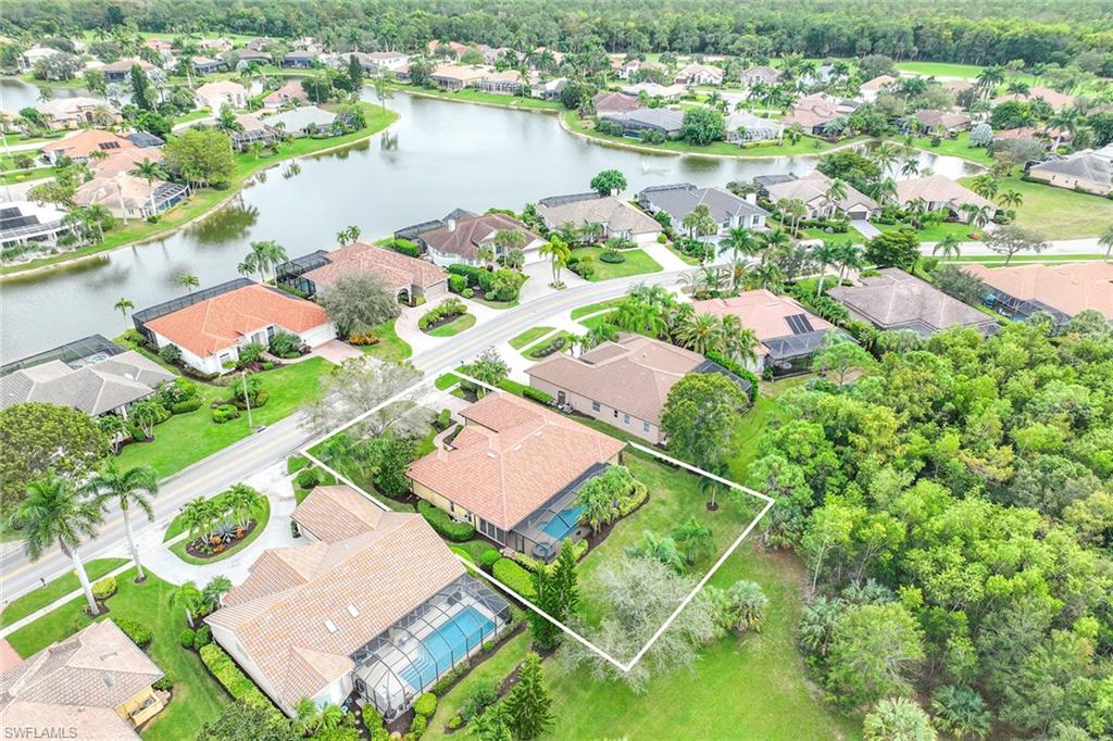 8862 Lely Island Circle Naples, FL 34113 - Photo 43 of 47 an aerial view of a house with a lake view