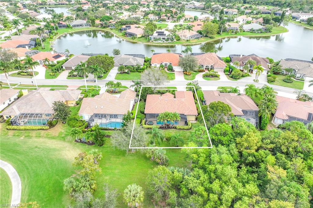 8862 Lely Island Circle Naples, FL 34113 - Photo 46 of 47 an aerial view of residential houses with outdoor space and swimming pool