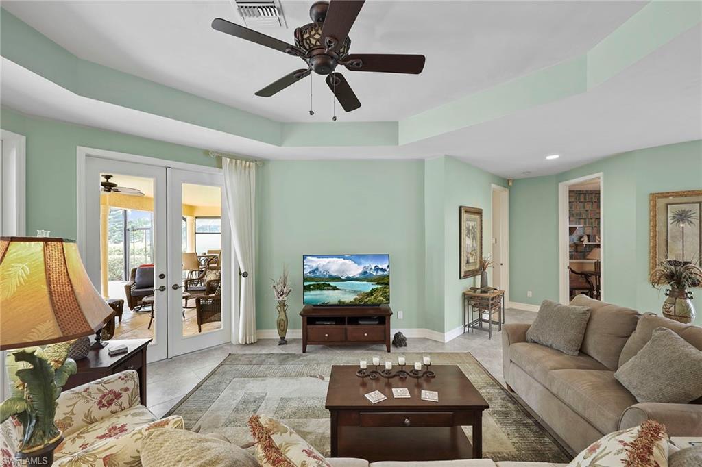 8862 Lely Island Circle Naples, FL 34113 - Photo 6 of 47 a living room with furniture and a flat screen tv