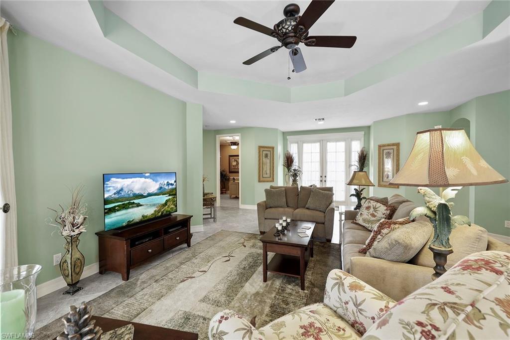 8862 Lely Island Circle Naples, FL 34113 - Photo 7 of 47 a living room with furniture and a flat screen tv