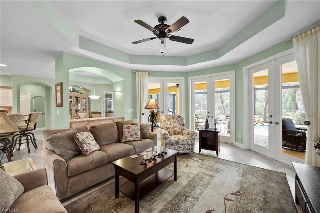 8862 Lely Island Circle Naples, FL 34113 - Photo 9 of 47 a living room with furniture and a large window with garden view